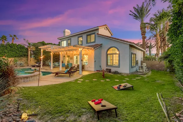 a view of a house with swimming pool and sitting area
