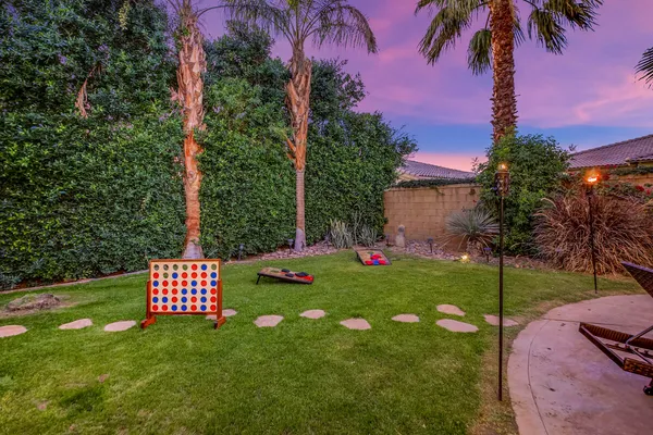 a view of a porch with a dining table and chairs
