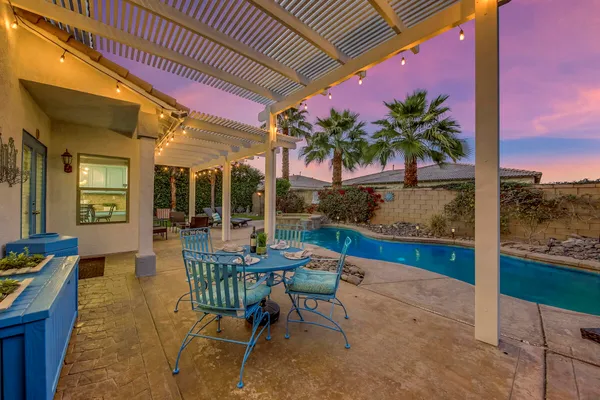 a bathroom with a granite countertop sink and a washing machine