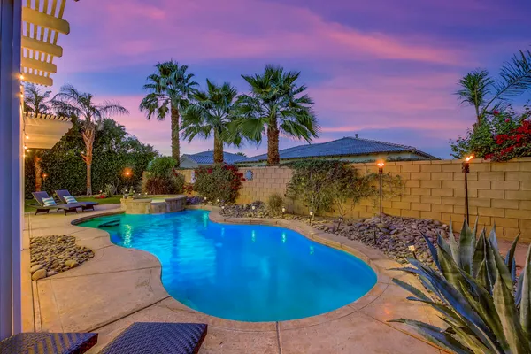 a view of a swimming pool with a yard