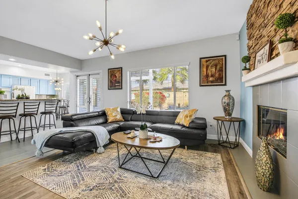 a living room with furniture a fireplace and a table