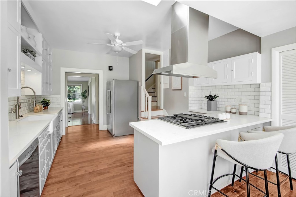 1632 Fletcher Avenue South Pasadena, CA 91030 - Photo 12 of 25 a kitchen with stainless steel appliances a stove a sink dishwasher and white cabinets with wooden floor