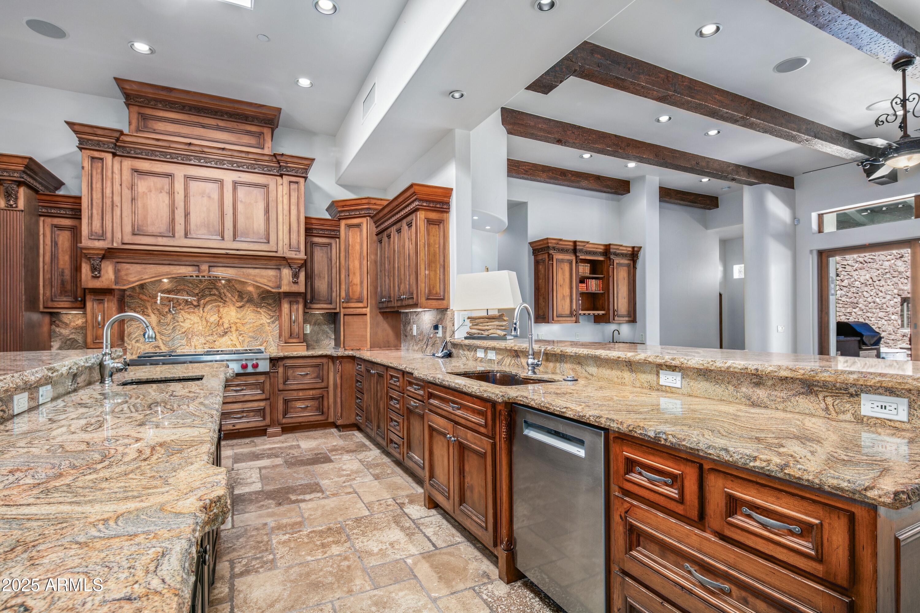 9533 East Rising Sun Drive Scottsdale, AZ 85262 - Photo 14 of 46 a kitchen with granite countertop a sink stove and cabinets