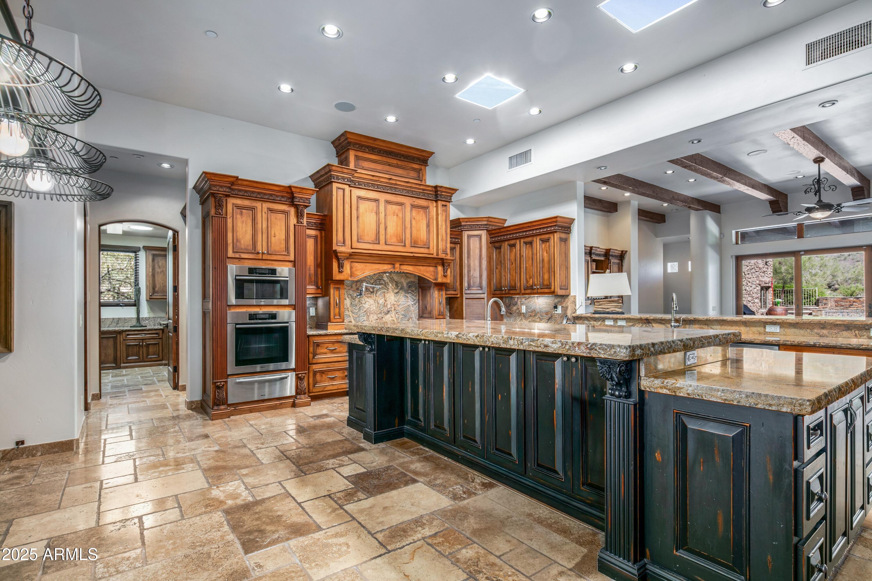 9533 East Rising Sun Drive Scottsdale, AZ 85262 - Photo 15 of 46 a kitchen with stainless steel appliances granite countertop a sink and cabinets