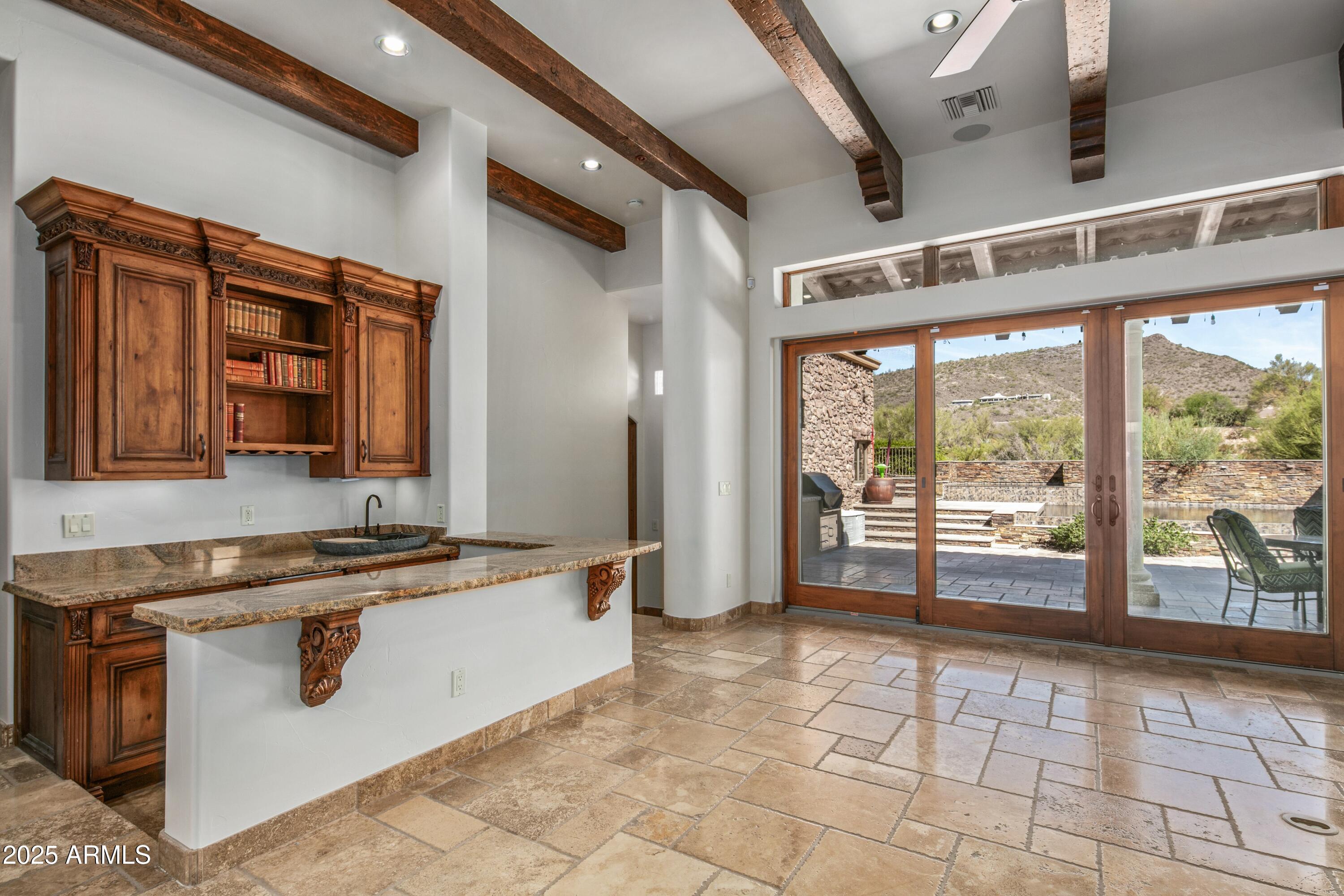 9533 East Rising Sun Drive Scottsdale, AZ 85262 - Photo 17 of 46 a view of a open kitchen with a sink and cabinets