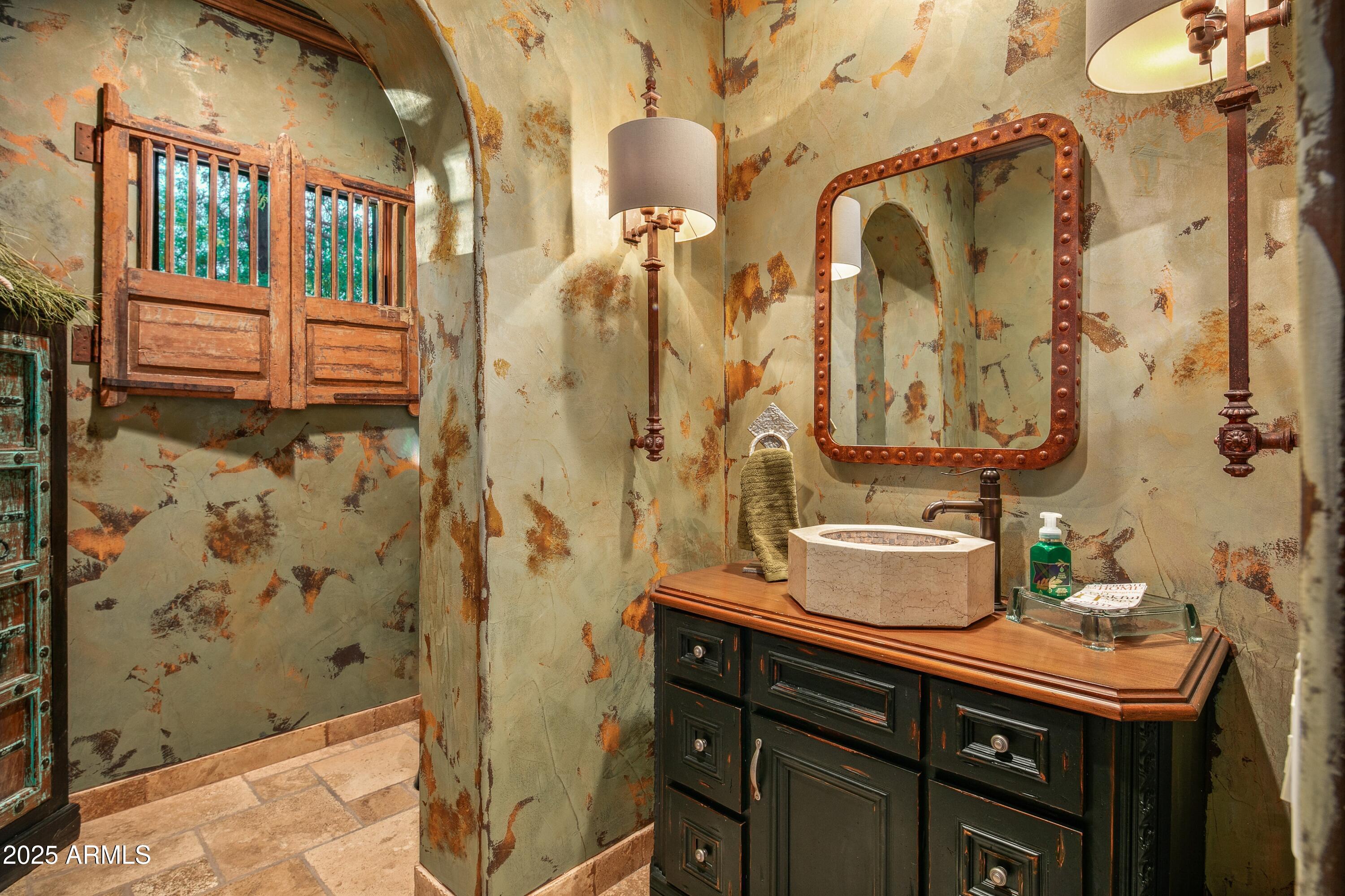 9533 East Rising Sun Drive Scottsdale, AZ 85262 - Photo 29 of 46 a bathroom with a sink and mirror with bathtub