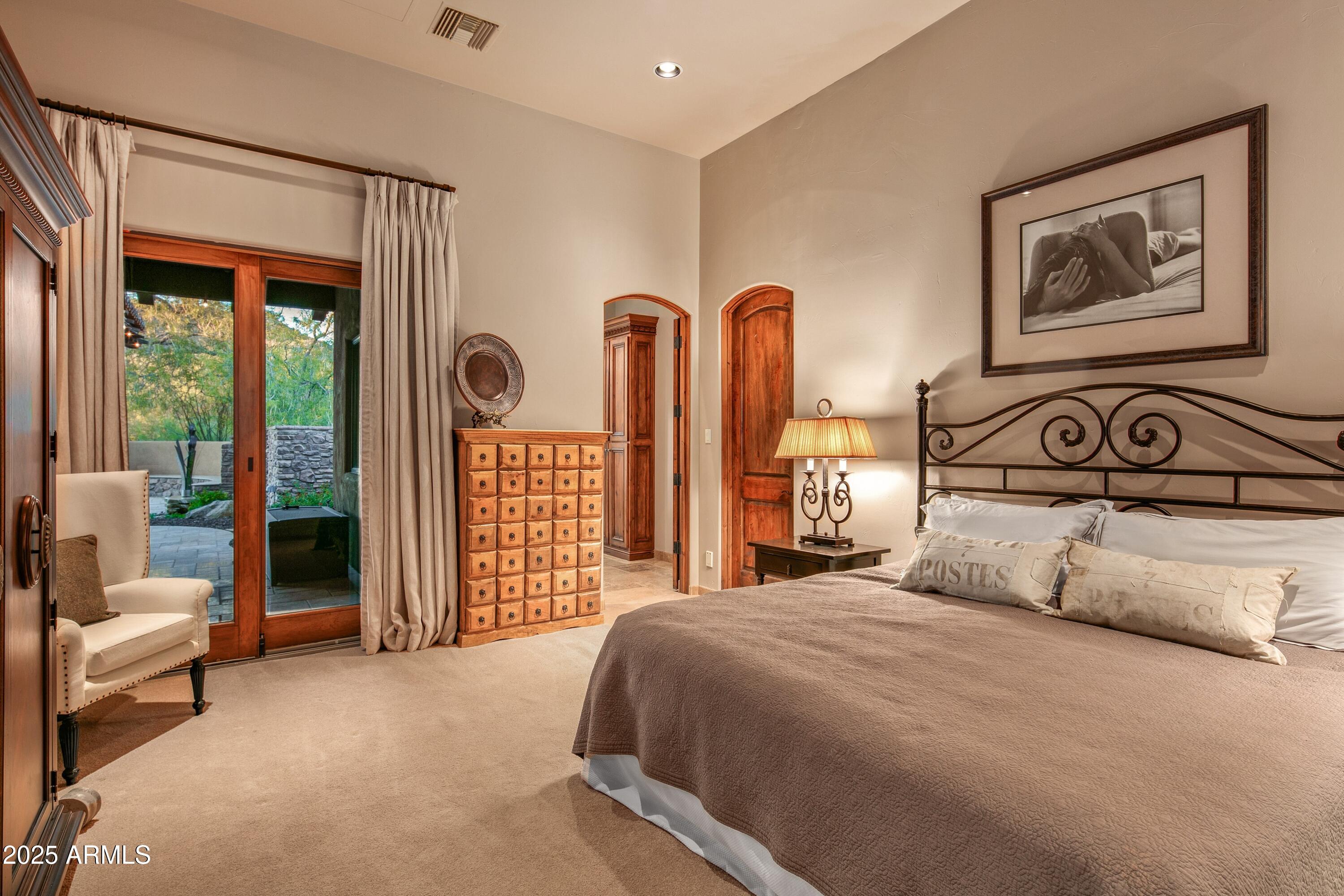 9533 East Rising Sun Drive Scottsdale, AZ 85262 - Photo 34 of 46 a bedroom with a large bed and a large window