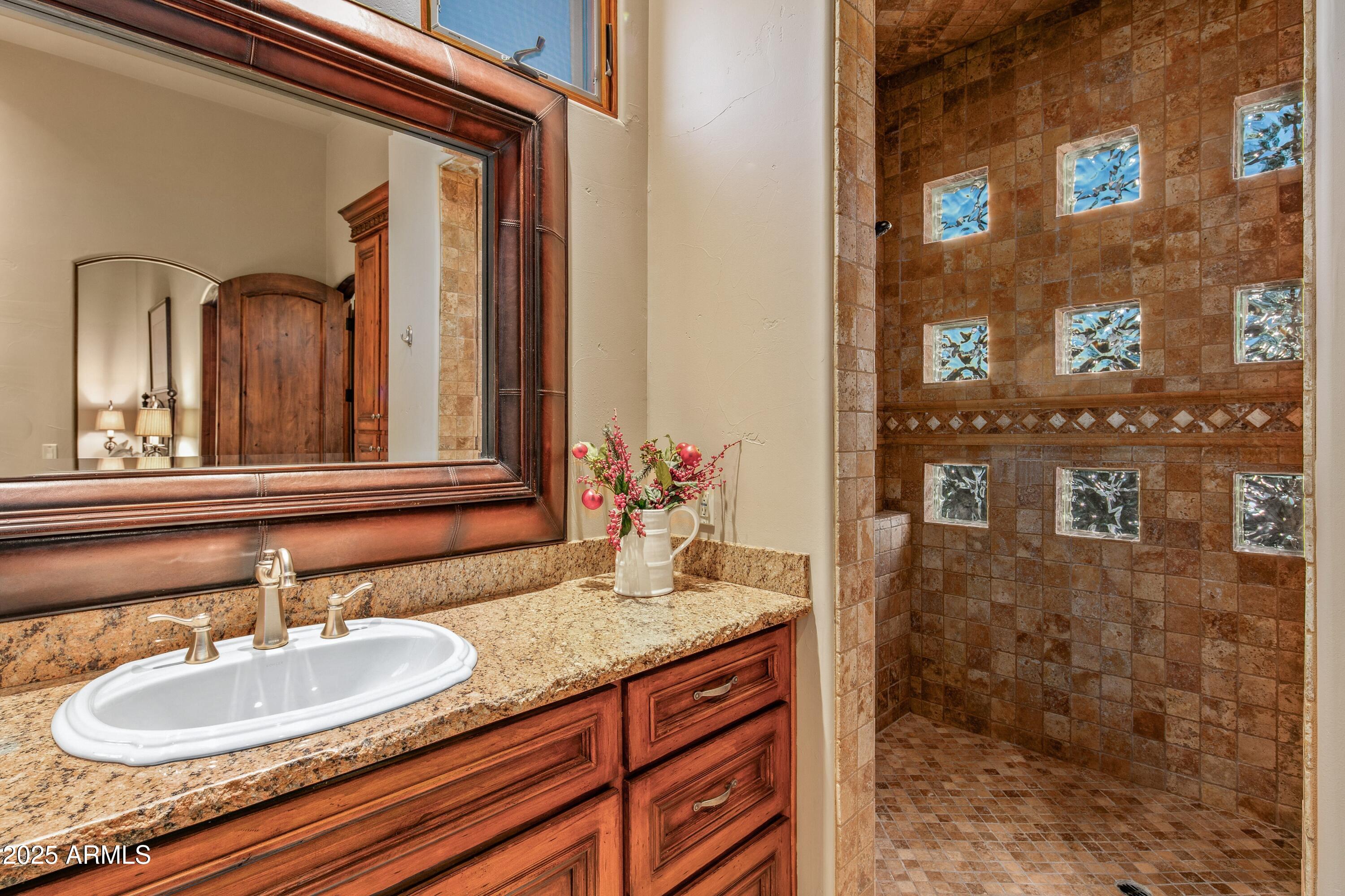 9533 East Rising Sun Drive Scottsdale, AZ 85262 - Photo 35 of 46 a bathroom with a sink and a mirror