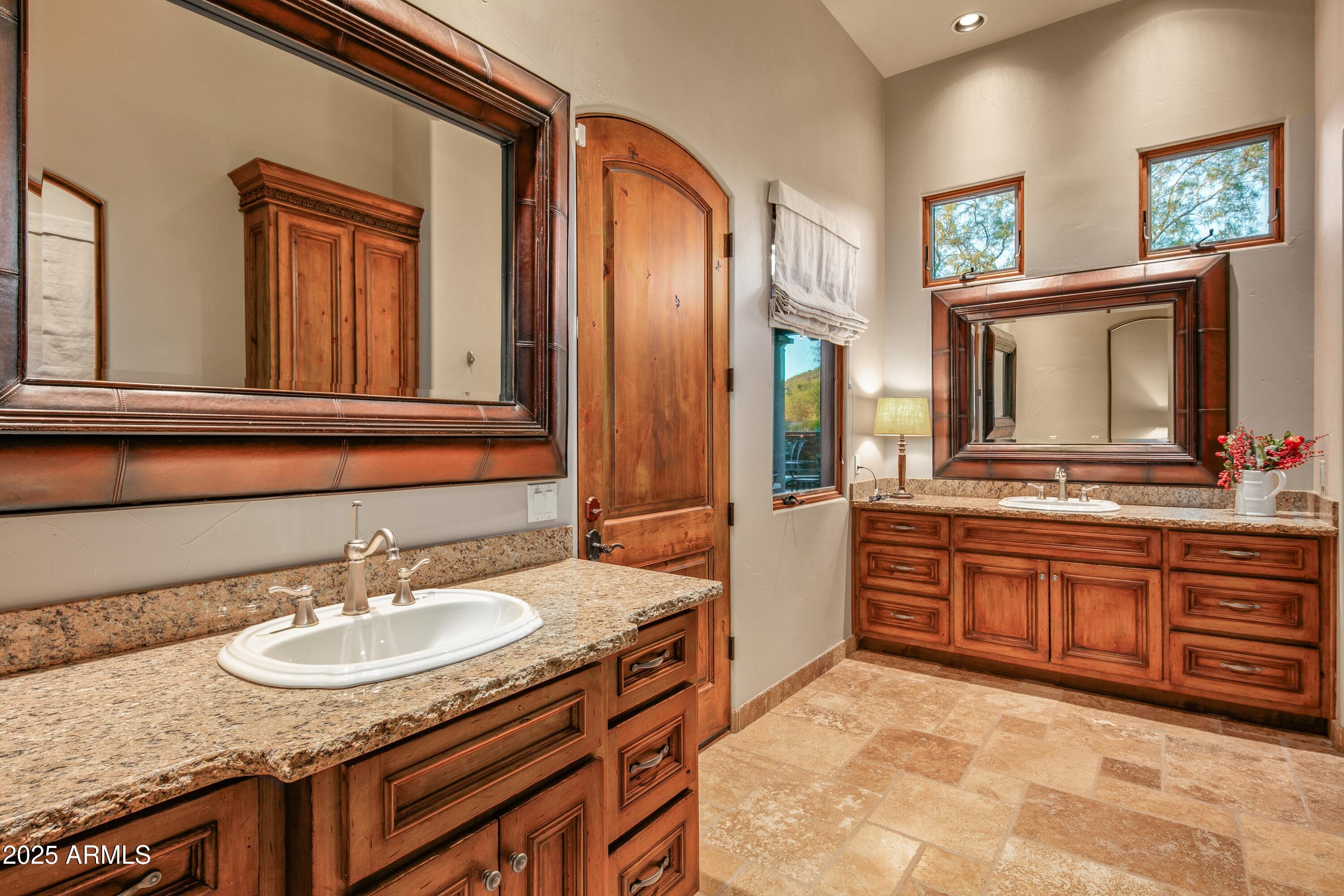 9533 East Rising Sun Drive Scottsdale, AZ 85262 - Photo 36 of 46 a bathroom with a granite countertop sink and a mirror