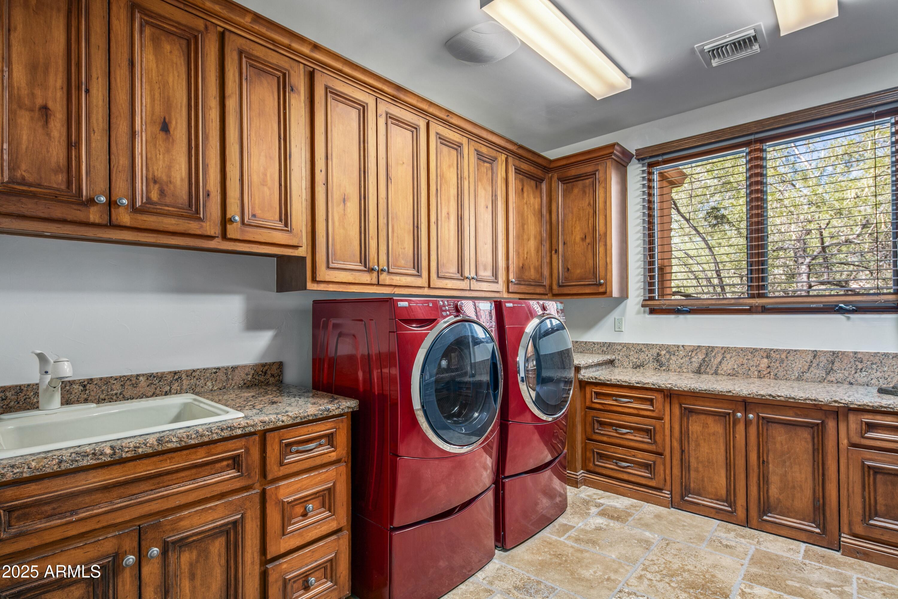 9533 East Rising Sun Drive Scottsdale, AZ 85262 - Photo 37 of 46 a utility room with stainless steel appliances granite countertop a stove a sink and dishwasher