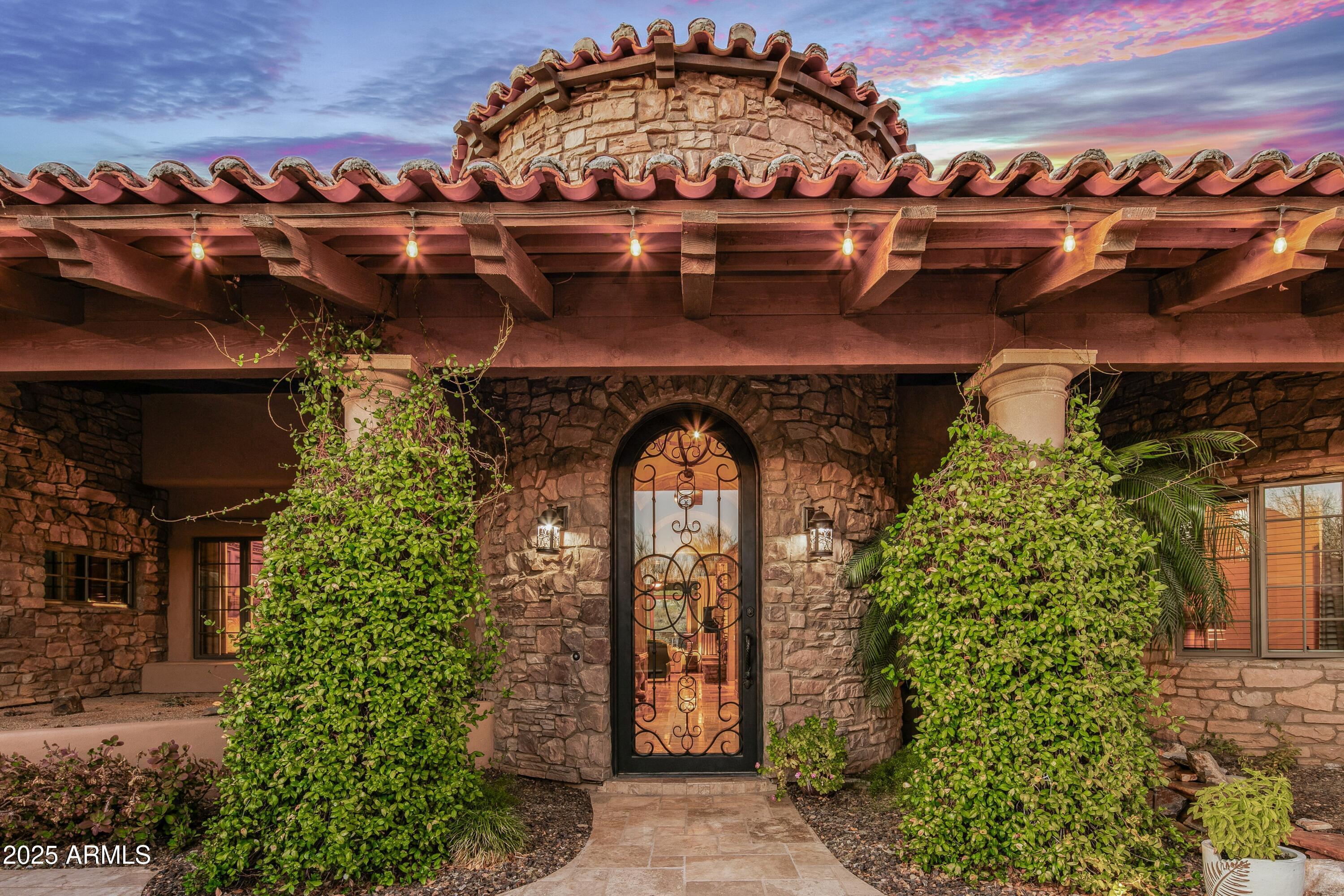 9533 East Rising Sun Drive Scottsdale, AZ 85262 - Photo 8 of 46 a front view of a house with a garden