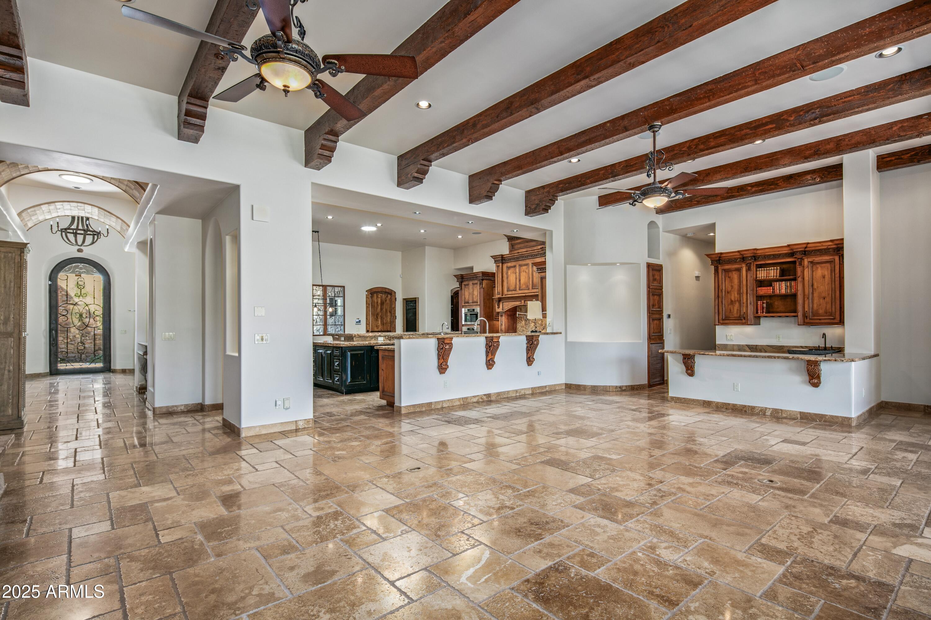 9533 East Rising Sun Drive Scottsdale, AZ 85262 - Photo 9 of 46 a view of a hallway with wooden floor and a kitchen