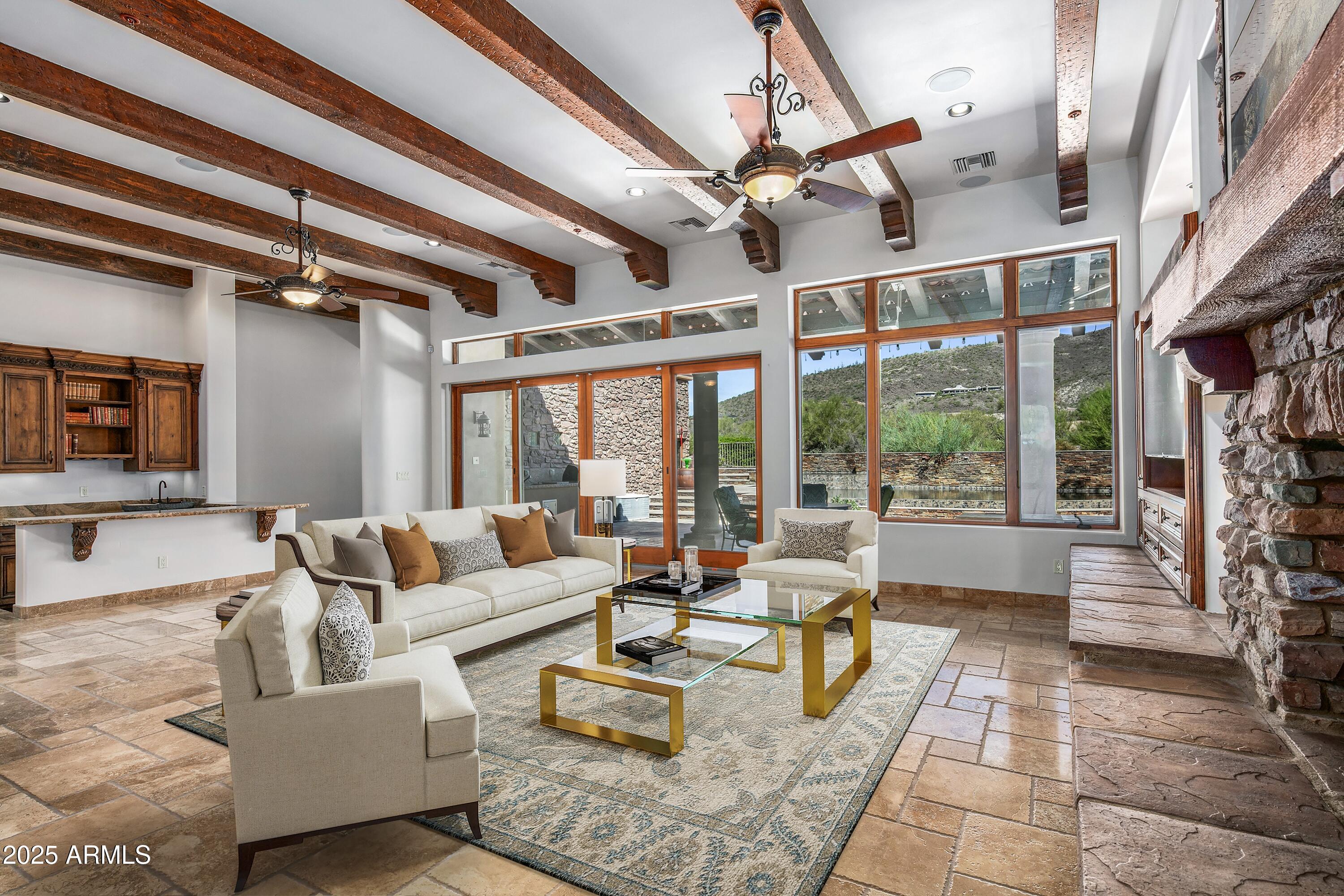 9533 East Rising Sun Drive Scottsdale, AZ 85262 - Photo 10 of 46 a living room with furniture and a chandelier