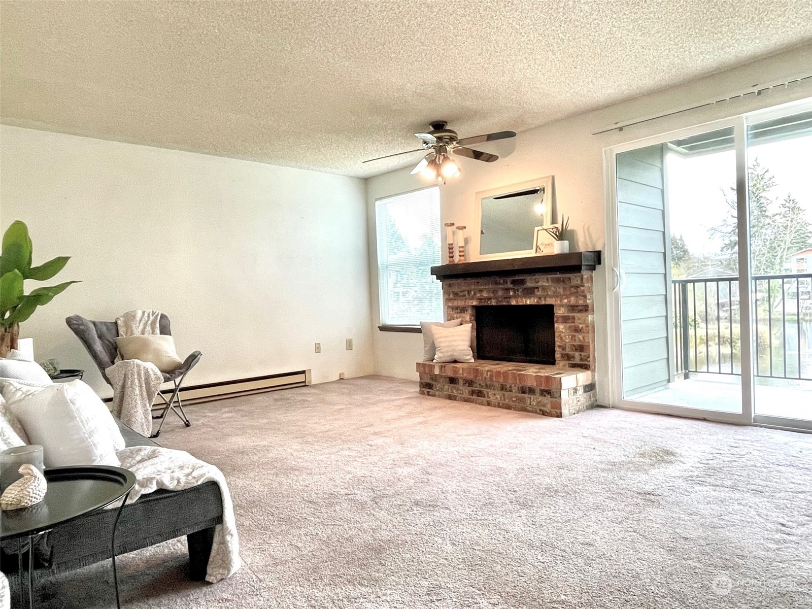820 Cady Road, Unit E205 Everett, WA 98203 - Photo 3 of 28 a living room with furniture a fireplace and a flat screen tv