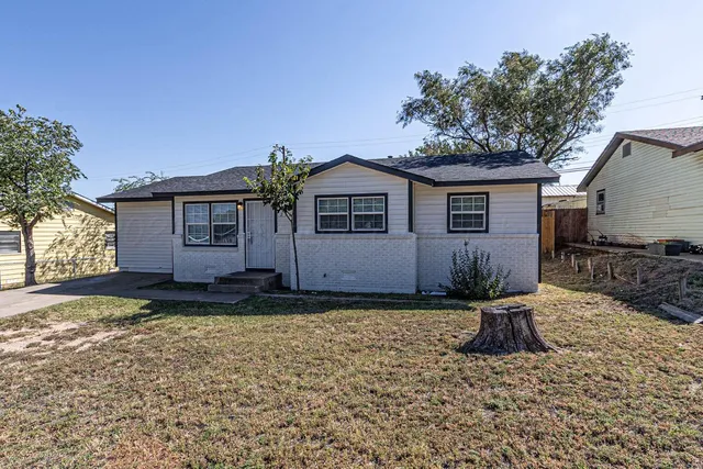 a house that has a tree in front of it