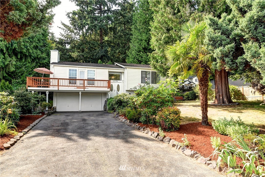 22708 3rd Avenue Southeast Bothell, WA 98021 - Photo 1 of 26 a front view of a house with a yard and trees