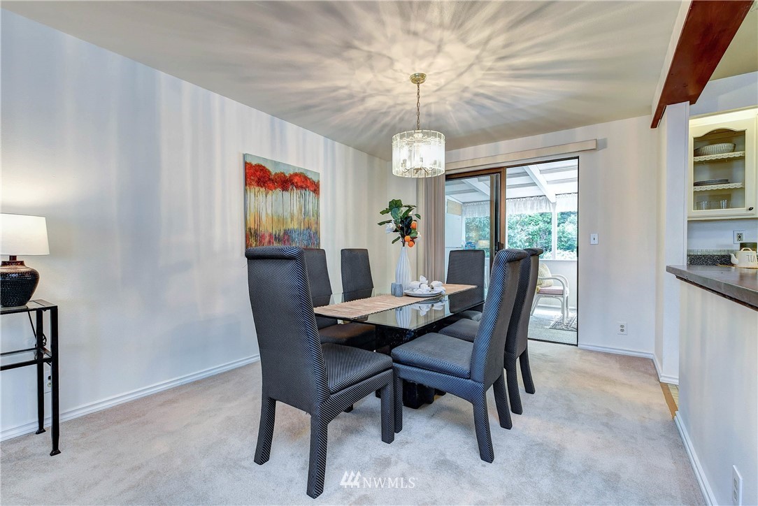 22708 3rd Avenue Southeast Bothell, WA 98021 - Photo 13 of 26 a view of a dining room with furniture wooden floor and chandelier