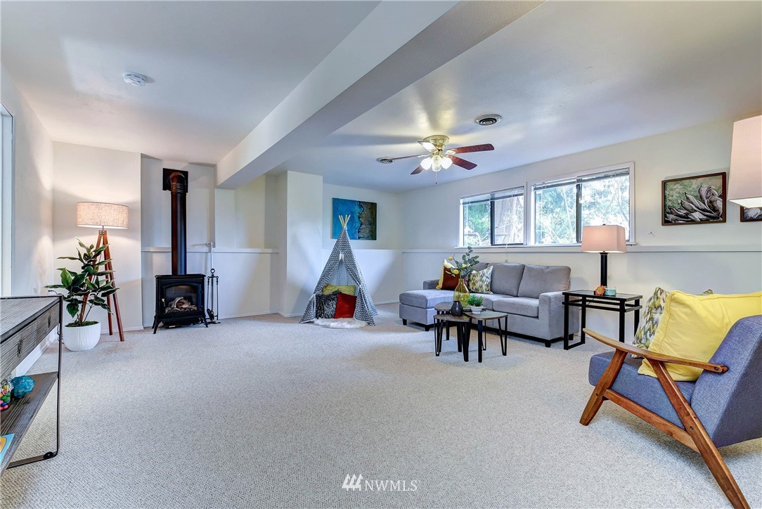 22708 3rd Avenue Southeast Bothell, WA 98021 - Photo 17 of 26 a living room with furniture and a chandelier