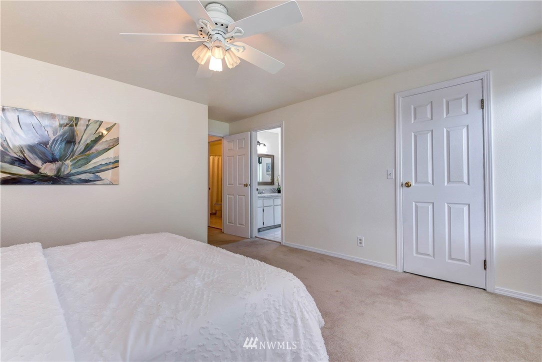 22708 3rd Avenue Southeast Bothell, WA 98021 - Photo 3 of 26 a bedroom with a bed and a chandelier