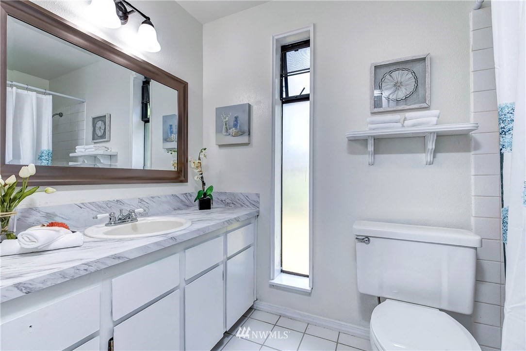 22708 3rd Avenue Southeast Bothell, WA 98021 - Photo 4 of 26 a bathroom with a toilet sink and mirror