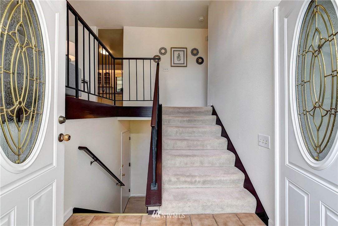 22708 3rd Avenue Southeast Bothell, WA 98021 - Photo 9 of 26 a view of a hallway with wooden floor and stairs