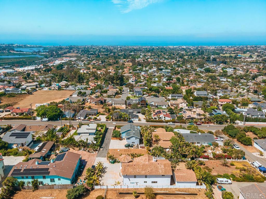 1780 Laurel Road Oceanside, CA 92054 - Photo 2 of 46 an aerial view of a city with lots of residential buildings and ocean view in back