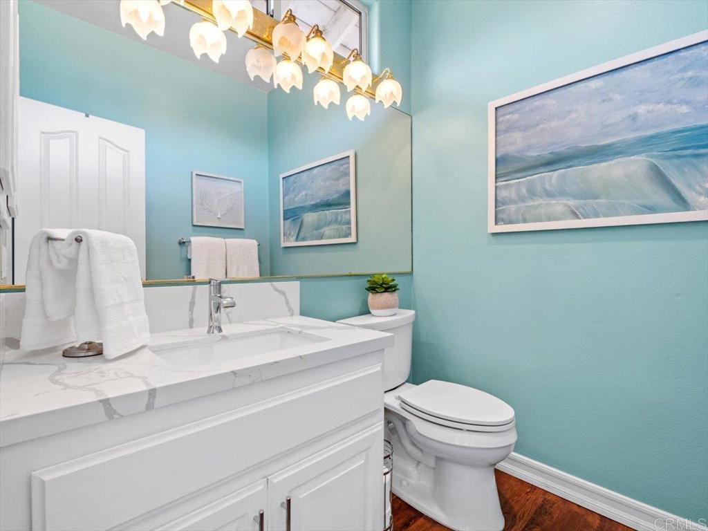 1780 Laurel Road Oceanside, CA 92054 - Photo 24 of 46 a bathroom with a toilet a sink and mirror