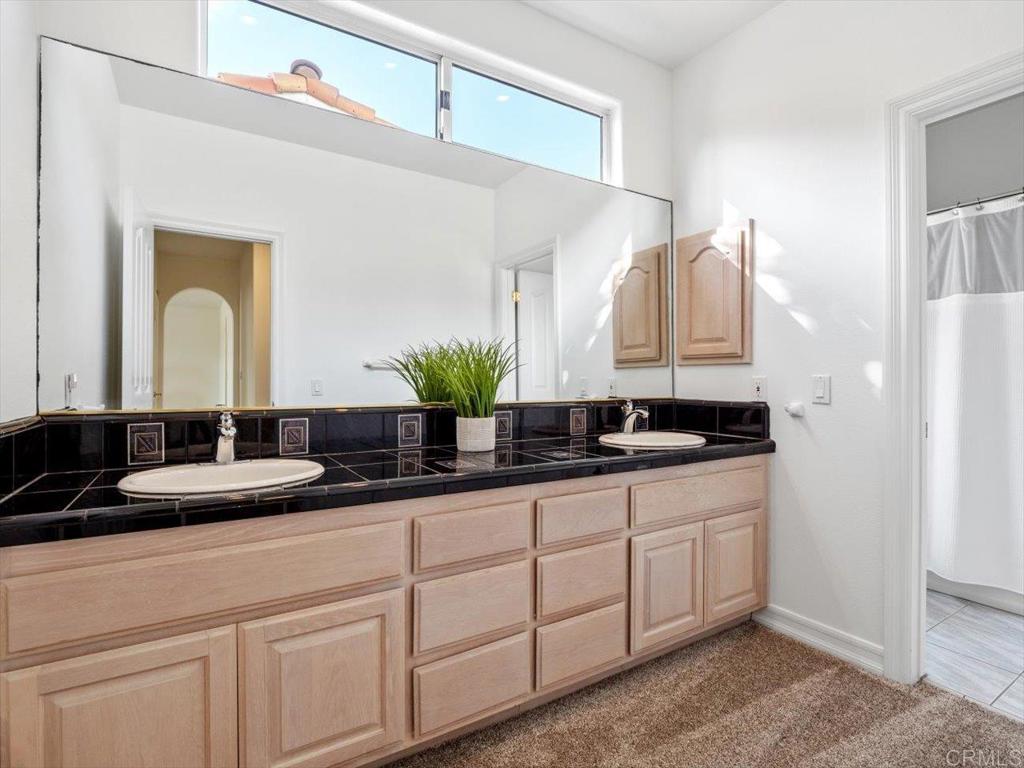 1780 Laurel Road Oceanside, CA 92054 - Photo 34 of 46 a bathroom with a double vanity sink and a mirror