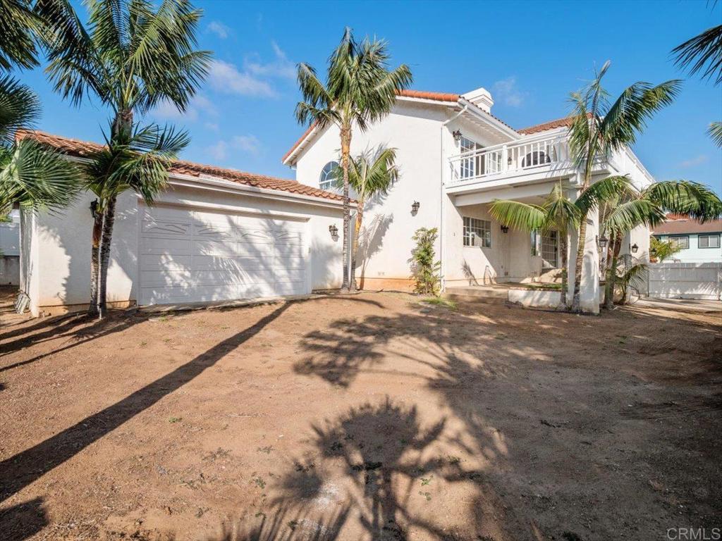 1780 Laurel Road Oceanside, CA 92054 - Photo 37 of 46 a view of a white house with a large tree and a yard