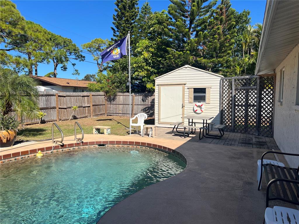 1228 Nantucket Road Venice, FL 34293 - Photo 11 of 32 a backyard of a house with table and chairs