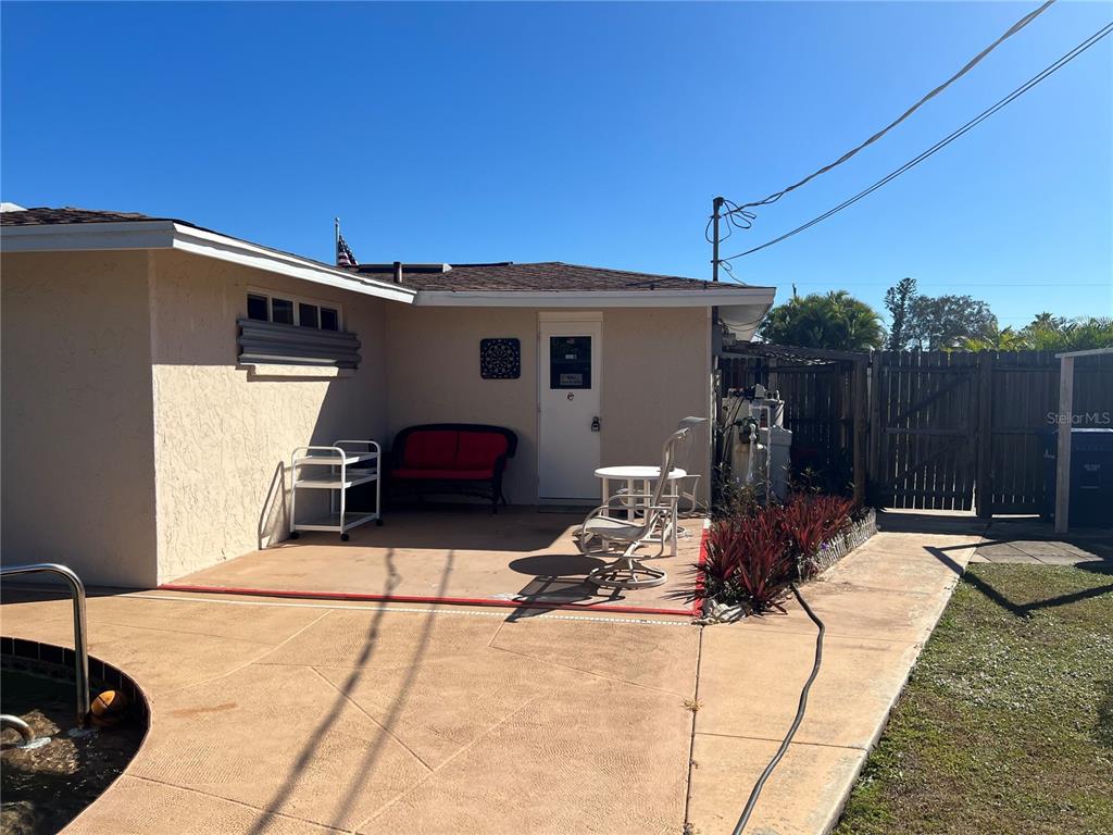 1228 Nantucket Road Venice, FL 34293 - Photo 15 of 32 a view of a patio with table and chairs with wooden fence and floor