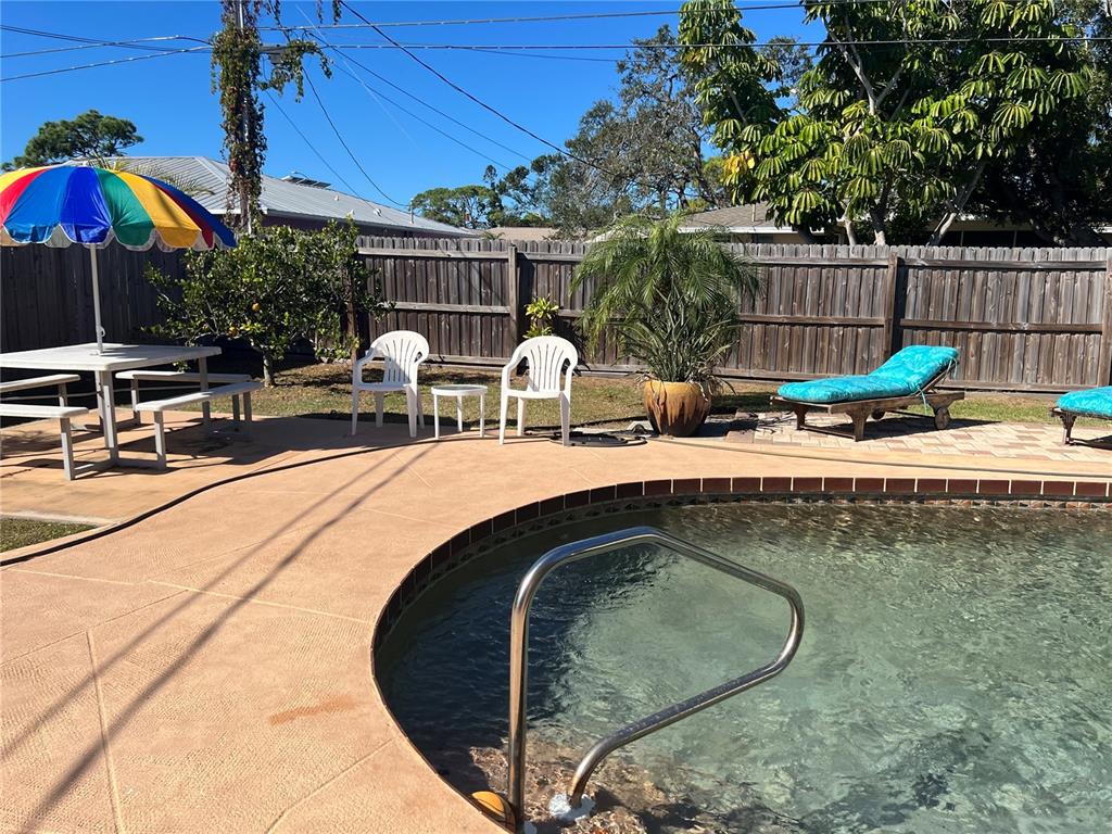 1228 Nantucket Road Venice, FL 34293 - Photo 16 of 32 a roof deck with table and chairs under an umbrella