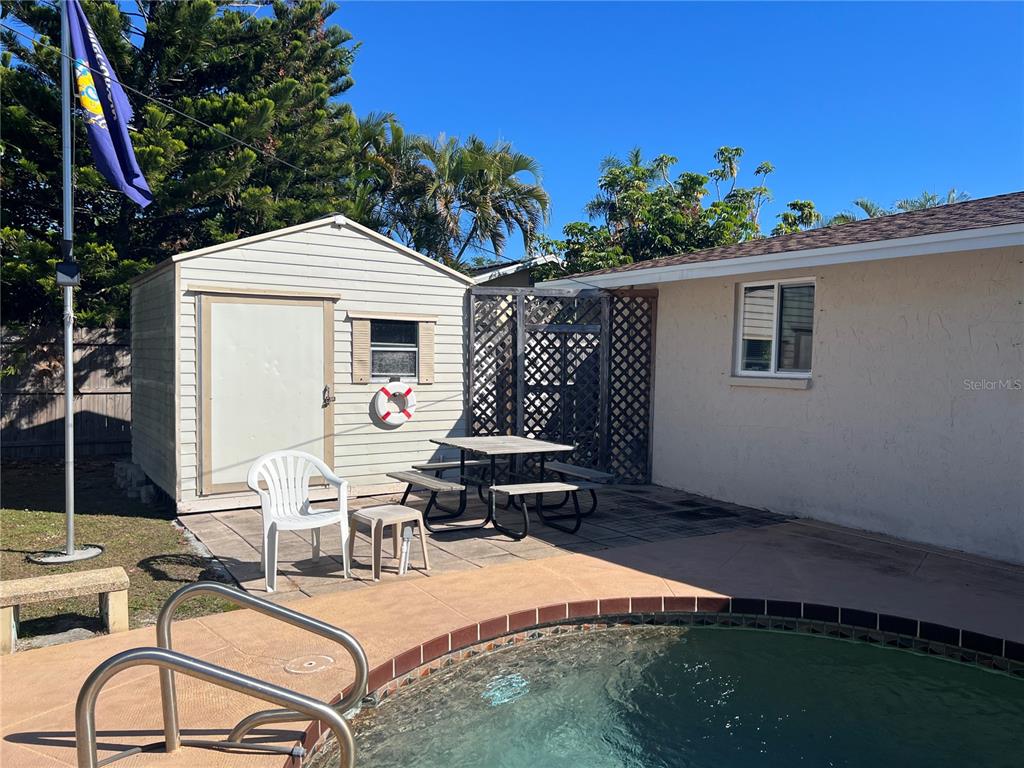 1228 Nantucket Road Venice, FL 34293 - Photo 18 of 32 a view of a patio with table and chairs with wooden floor and fence