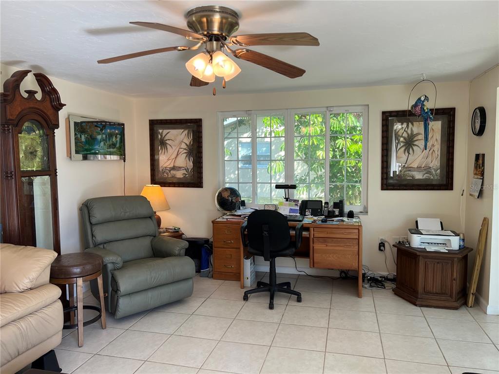 1228 Nantucket Road Venice, FL 34293 - Photo 21 of 32 a living room with furniture and a large window