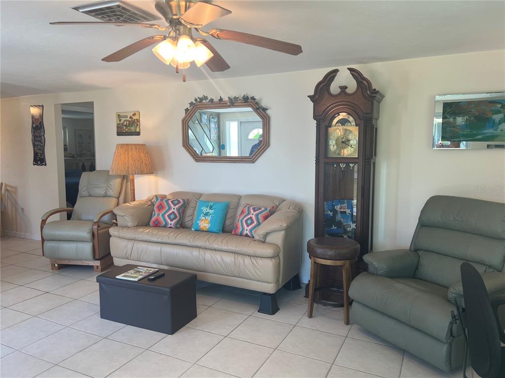 1228 Nantucket Road Venice, FL 34293 - Photo 22 of 32 a living room with furniture and a mirror