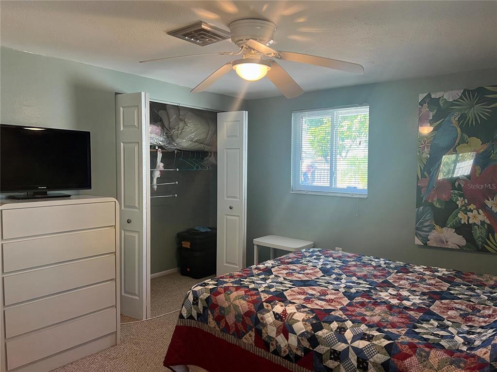 1228 Nantucket Road Venice, FL 34293 - Photo 25 of 32 a bedroom with a bed and flat screen tv