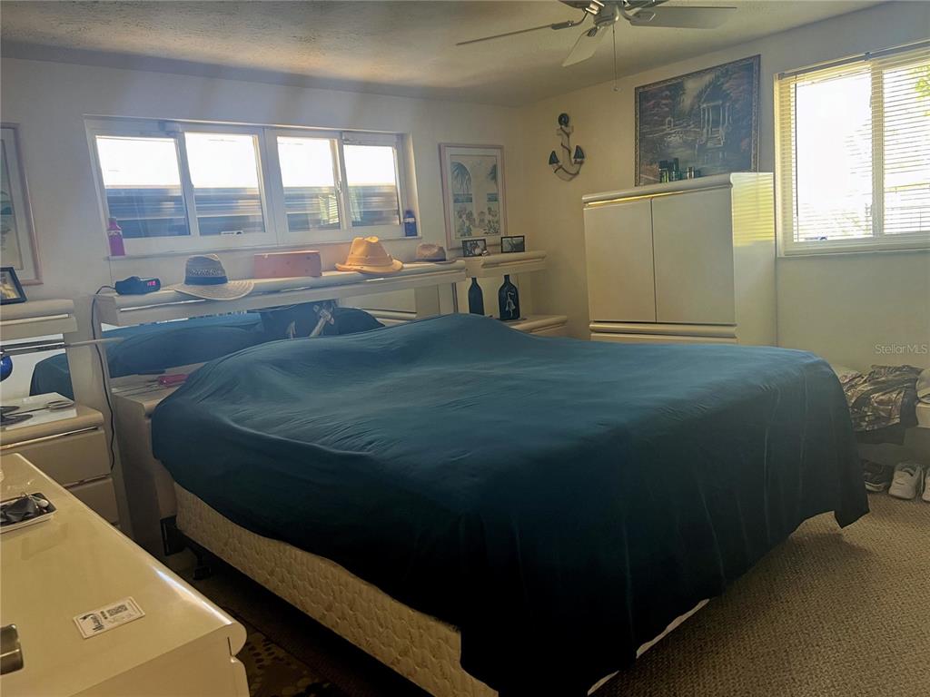 1228 Nantucket Road Venice, FL 34293 - Photo 28 of 32 a bed sitting in a bedroom next to a window