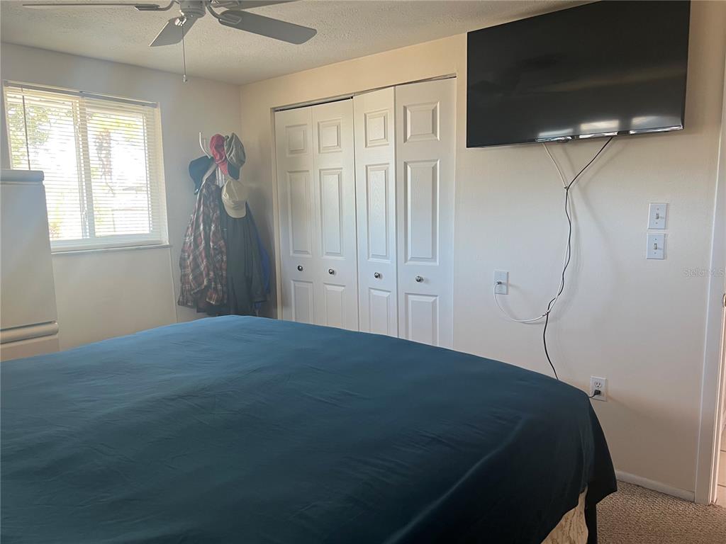 1228 Nantucket Road Venice, FL 34293 - Photo 29 of 32 a bed sitting in a bedroom next to a window