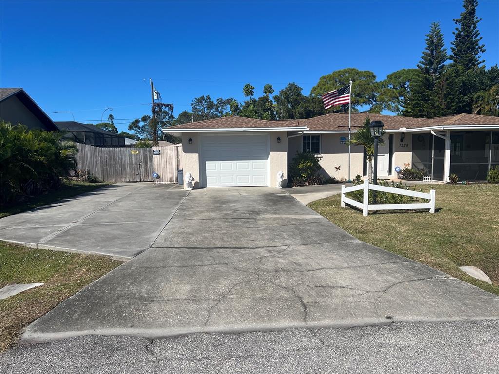 1228 Nantucket Road Venice, FL 34293 - Photo 8 of 32 a view of a house with a yard and potted plants