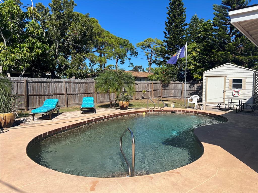 1228 Nantucket Road Venice, FL 34293 - Photo 9 of 32 a view of a swimming pool with a patio