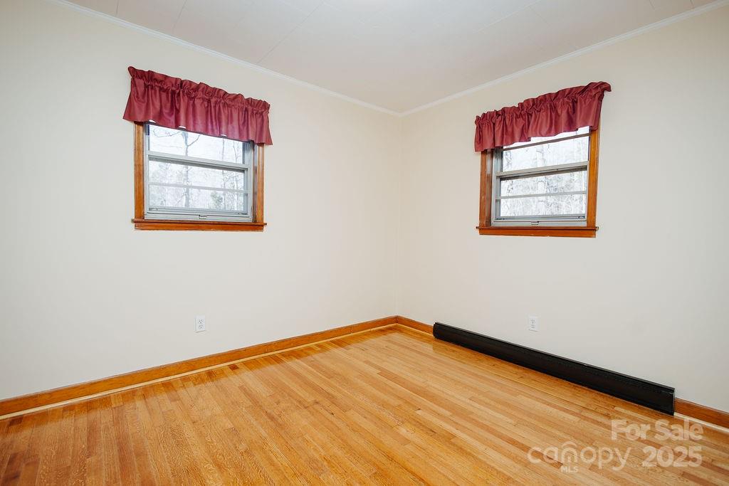 541 Romine Drive Marion, NC 28752 - Photo 11 of 23 a view of a big room with wooden floor and windows