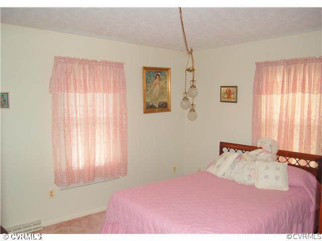 17401 Elko Road Petersburg, VA 23803 - Photo 7 of 12 a bedroom with a bed and a window