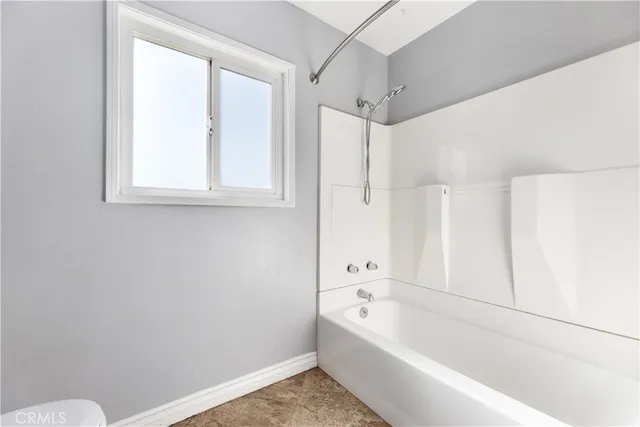 a view of a room with wooden floor and a window