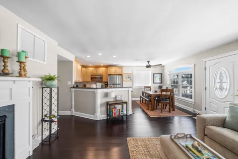 a living room with dining room and wooden floor