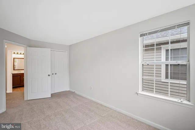 a bathroom with a bathtub shower sink vanity mirror and toilet
