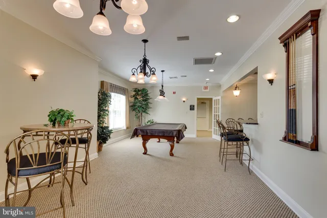 a living room with furniture a chandelier and a flat screen tv