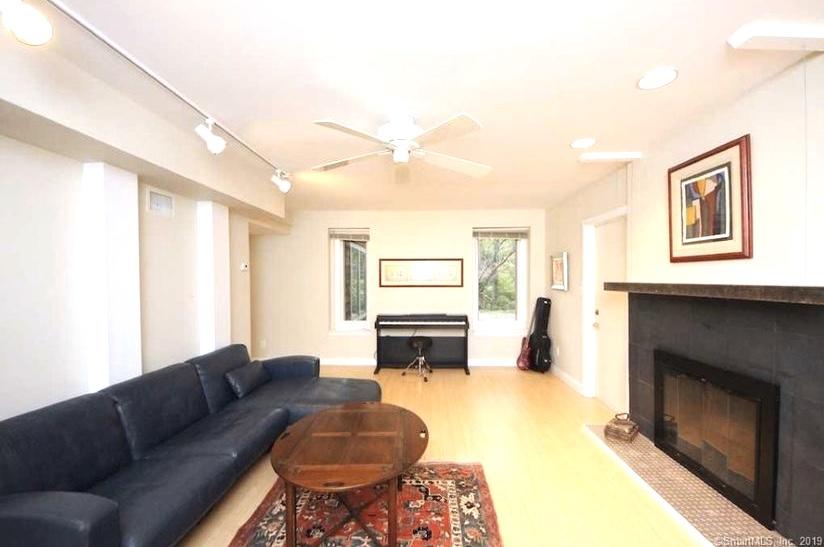 3 Little Brook Road Rowayton, CT 06853 - Photo 12 of 17 a living room with furniture a large window and a fireplace