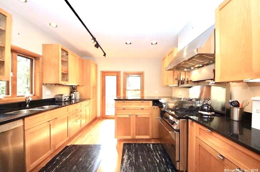 3 Little Brook Road Rowayton, CT 06853 - Photo 3 of 17 a kitchen with stainless steel appliances a stove a sink and a wooden floor
