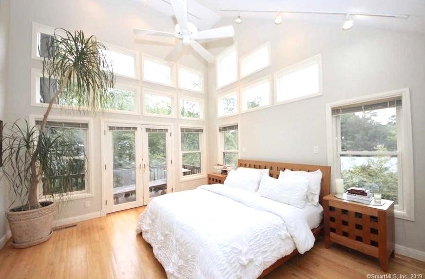 3 Little Brook Road Rowayton, CT 06853 - Photo 5 of 17 a bedroom with a large bed and a large window