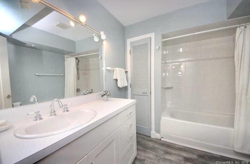 3 Little Brook Road Rowayton, CT 06853 - Photo 6 of 17 a bathroom with a bathtub shower sink and a mirror